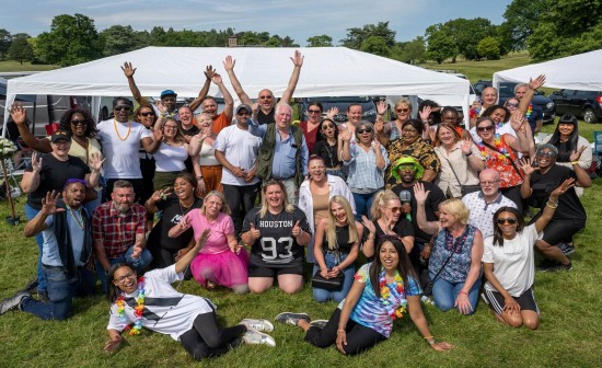 a large group of P3 staff members smiling and cheering